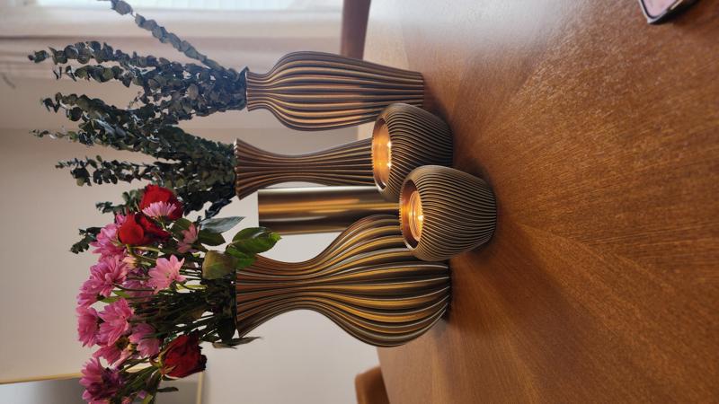 Black and gold ridged vase collection with flowers