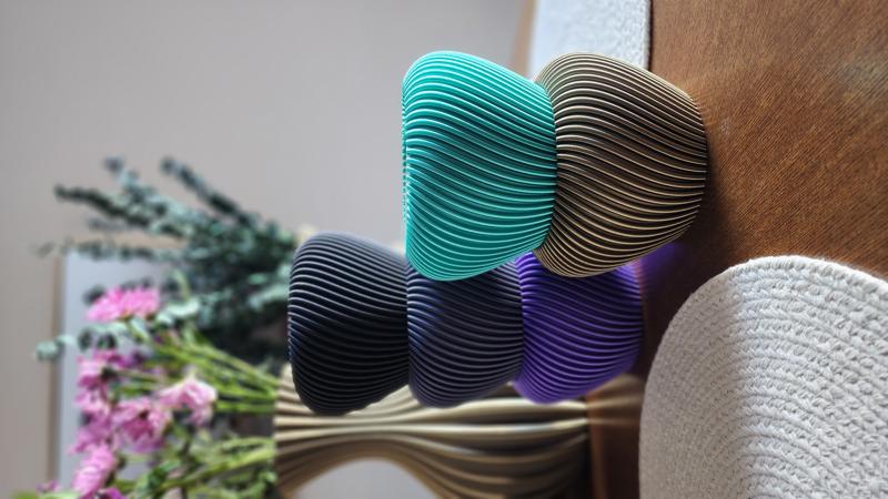 Colorful swirl bowls stacked — turquoise, purple, black, gold